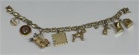 14KT Gold Bracelet W/ 9 Gold Charms Marled 14KT.