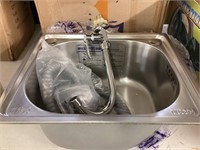 Small bar sink with faucet* corner is slightly