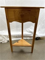 Wood corner table. Approximately 29 inches tall.
