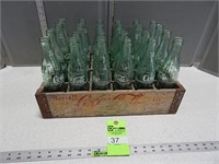 Case of coke bottles, with wooden coke case