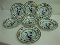 Seven Edwardian ironstone polychromed plates in