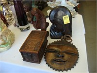 Three African carvings, two of faces and one of a