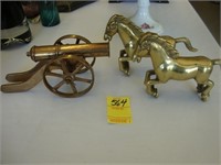 8" brass cannon along with two brass horses.
