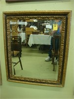 Beveled wall mirror in gilt frame, 24” x 28”.