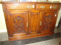 TOC oak sideboard with brass hardware and carved