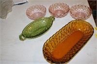 Amber colored, green and pink colored bowls