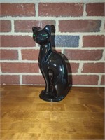 Beautiful black cat statue with green eyes