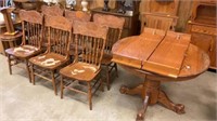 Dining room table with six chairs, shows wear