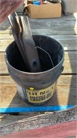 Bucket with lawn mower blades.