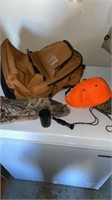 Carhartt backpack and orange/camo ball cap, duck