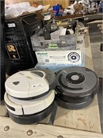 Group of Roomba Style Vacuums