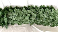 Four pieces of plastic fencing with greenery