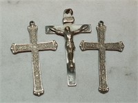 OF) One crucifix and two cross pendants