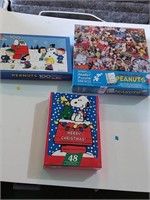 3 unopened snoopy puzzles