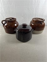 Stoneware crocks with lids. One marked Red Wing