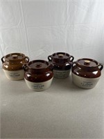 Stoneware advertising crocks with lids. All are 6