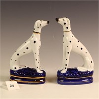 A pair of ceramic dog sculptures
