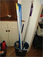 Bucket with mops and curtain rods