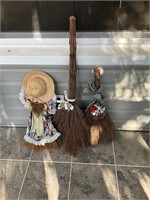 Three decorative stick brooms