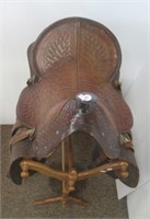 Tooled leather horse saddle. Seat measures 17".