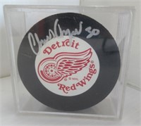 Chris Osgood signed Detroit Red Wings hockey puck.