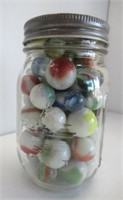 5.25" Tall jar filled with marbles.