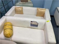 PAIR OF CREAM COLORED VINYL SOFAS 68IN LONG BY 33I
