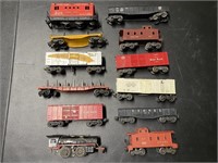 (11) MODEL TRAIN CARS & (1) TIN "LIONEL JR."