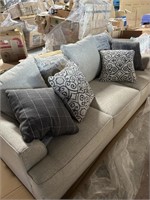 Grey Pullout Sofa w Decorative Pillows.