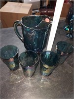 Carnival glass pitcher and cups