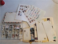 Box and folder of assorted stamps postcards &
