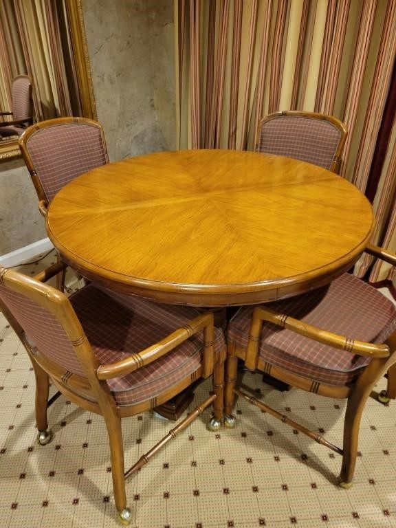 Brown wooden table with 4 chairs on rollers