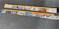 15 Retro Metal license plates on a wood board.