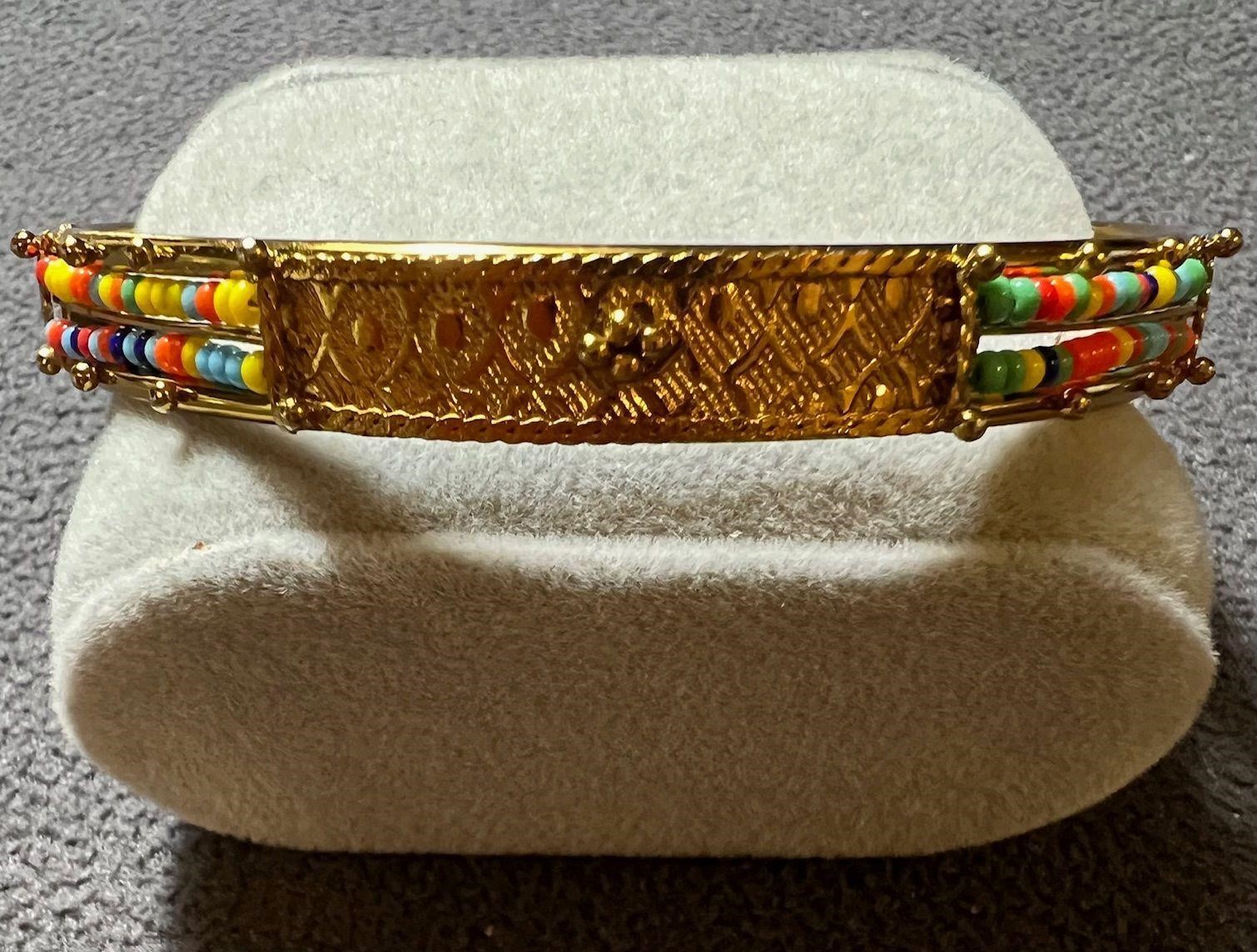 GOLD TONE BANGLE WITH BEADING