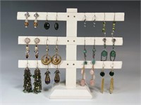 COLLECTION OF EARRINGS ON DISPLAY STAND