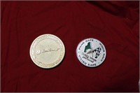 Two Excel energy challenge coins