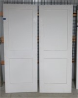 (2) Matching 2-panel wood interior door slabs.