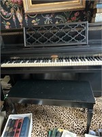 Black lacquered piano with bench