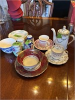 Collection of salt/peppers, tea sets and plates