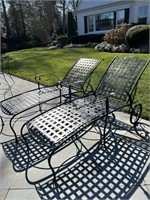 Pair of wrought iron lounge chairs with wheels