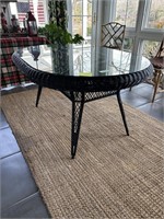 Black wicker dining table with glass top