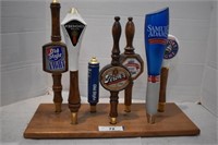 Seven Beer Tap Handles on Wood Stand