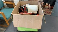 Box of Christmas sweaters, shirts and decorations