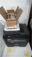 Brother printer with paper and small box of parts
