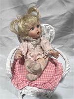 Vintage Porcelain Doll on Wicker Chair