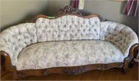 Antique upholstered and carved wood sofa