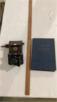 Vintage camera, triumph tragedy book