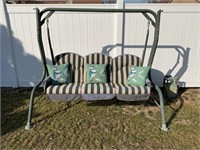 Outdoor patio swing with cushions and pillows