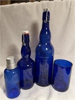 Assorted cobalt, blue bottles, and glassware