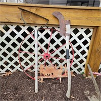Wheel, old tools and lawn decor with chickens